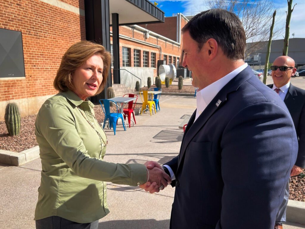 Governor Doug Ducey shakes Sharon Marvin's hand during a tour of the PSG facility (March 2022)